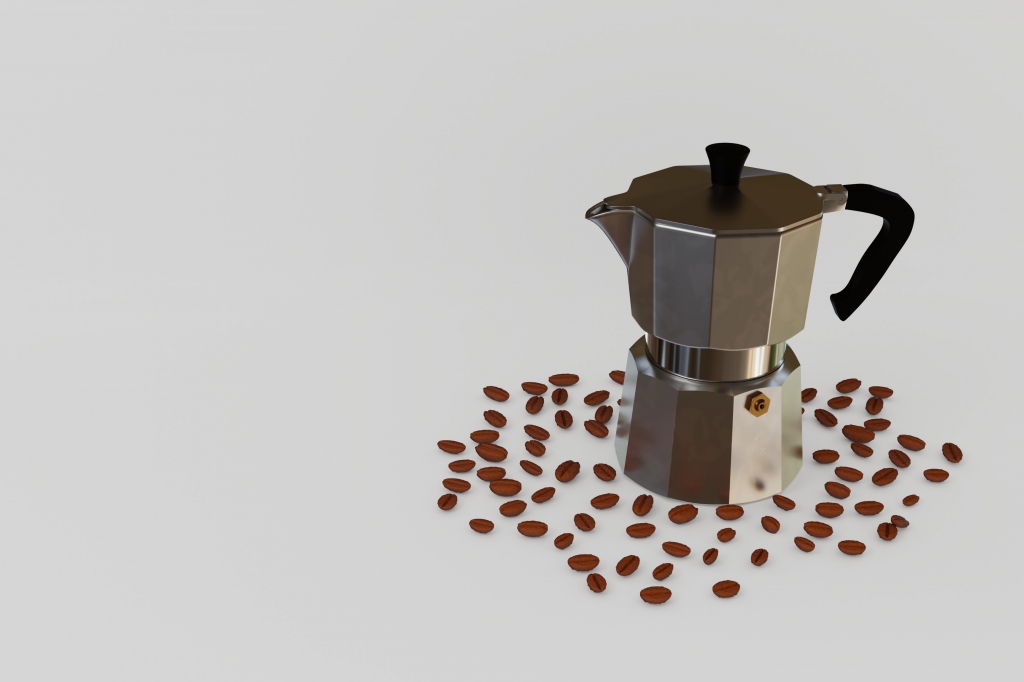 caffettiera con chicchi di caffè su sfondo bianco