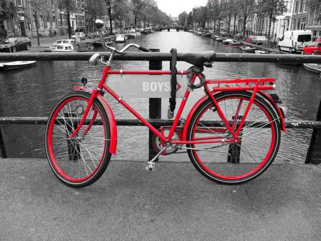 Amsterdan red bike on the channel