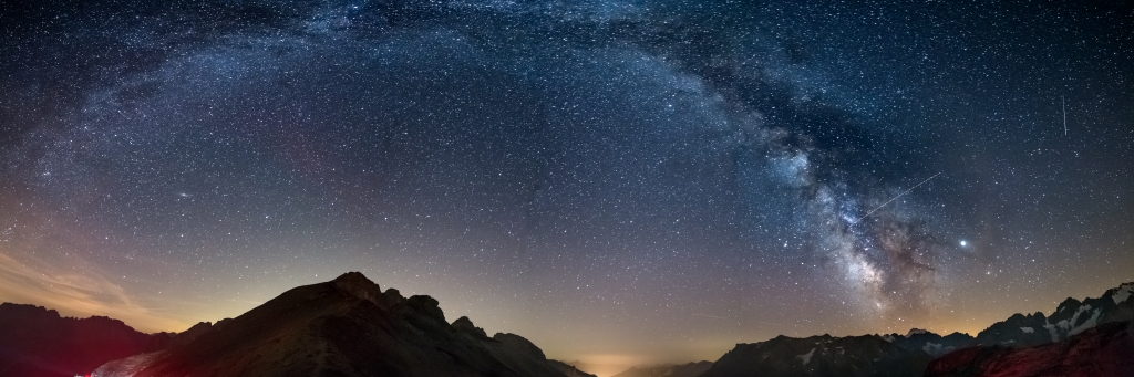 The Milky Way arc and starry sky on the Alps