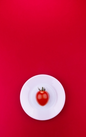 Tomato on a red background