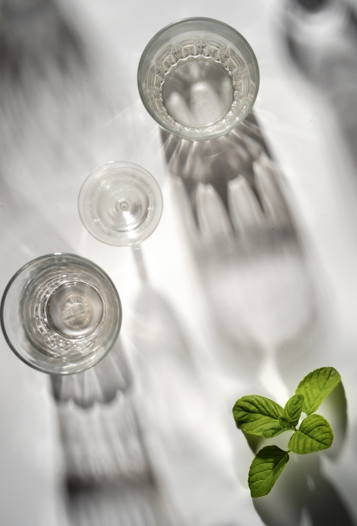 Top view of glasses on white table with mint leaves