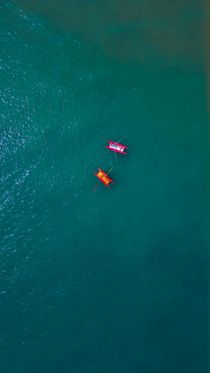 Rescue boats at sea viewed from a drone