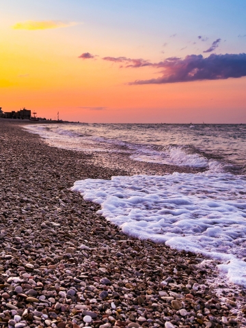 spiaggia di ciotoli al tramonto